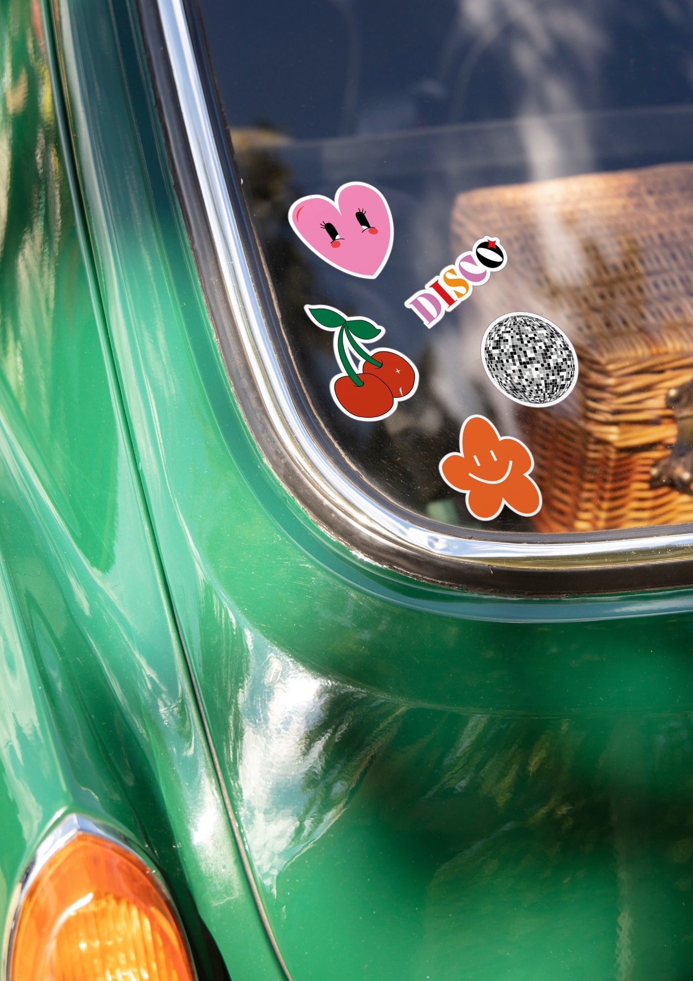 Pare brise arrière d'une voiture style fiat 500 avec cinq stickers collé dessus.